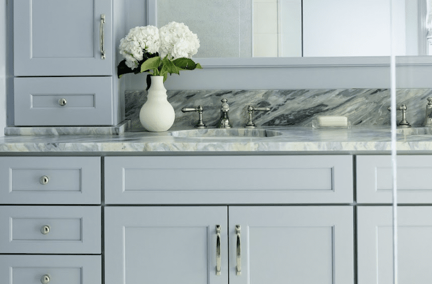 Screenshot 2025-06-13 at 12.34.23 PM Blue gray bathroom vanity with marble countertop and polished nickel fixtures by Design House Interiors